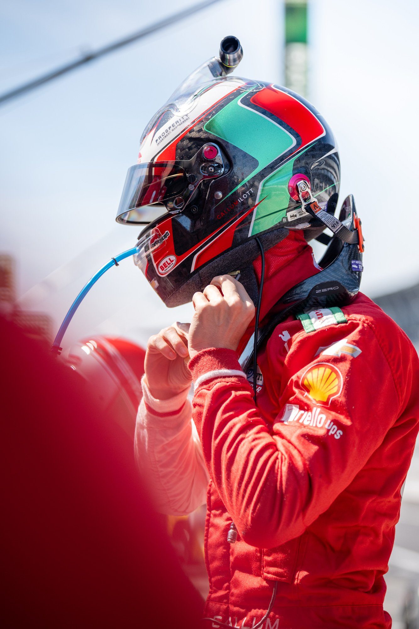 A PREMA driver fastening his helmet before a session