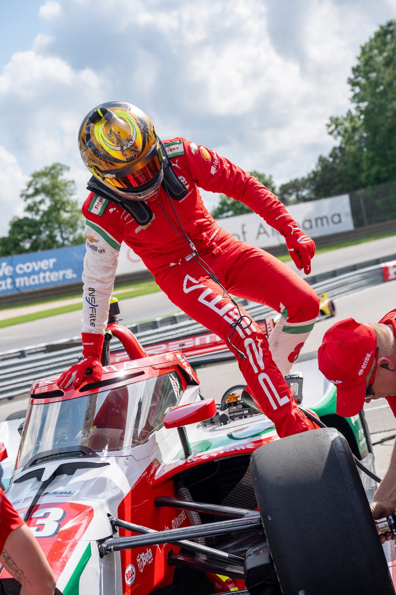 A PREMA driver climbing into the cockpit during a pit stop