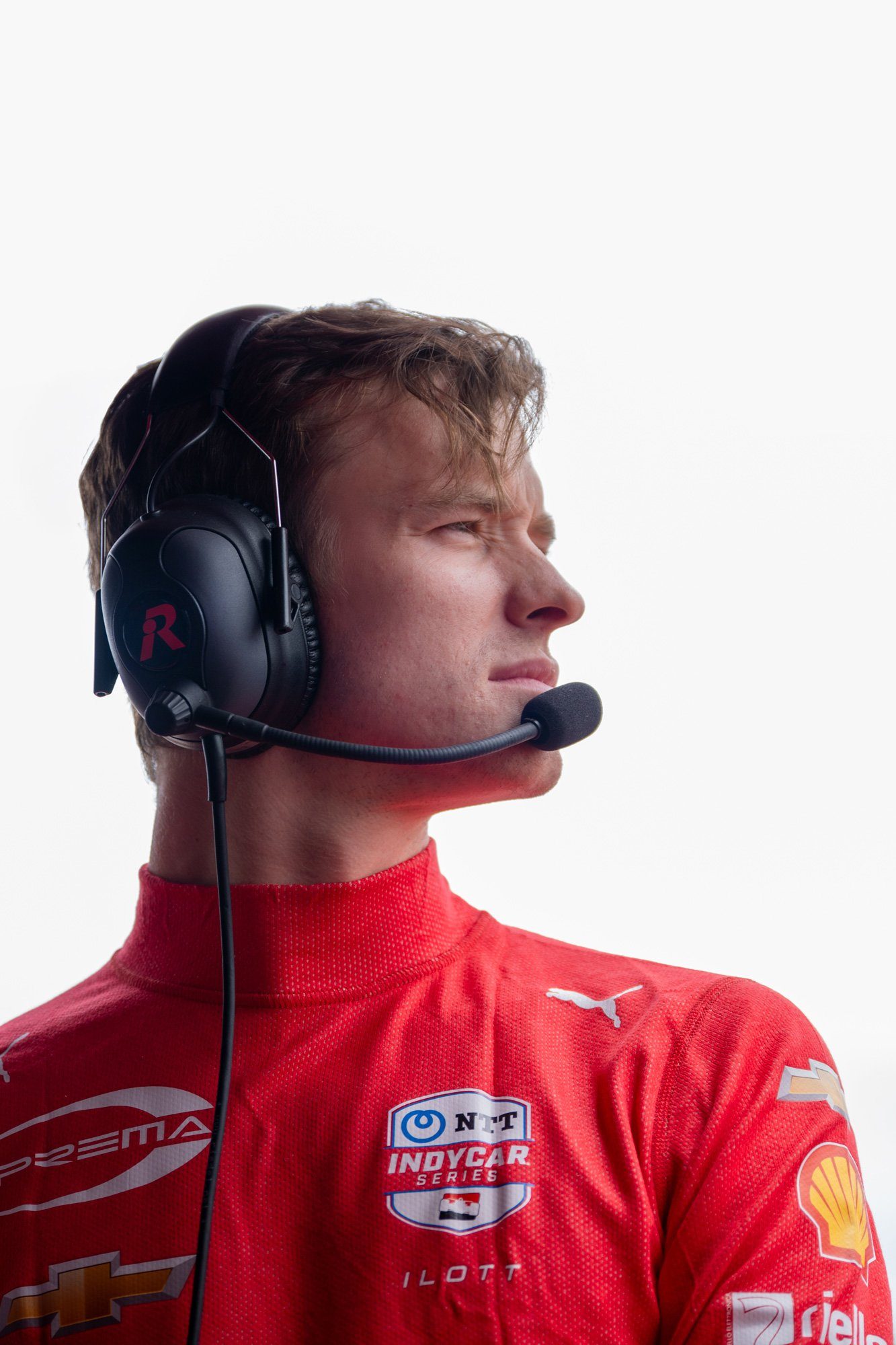 A PREMA driver in headset listening on the timing stand