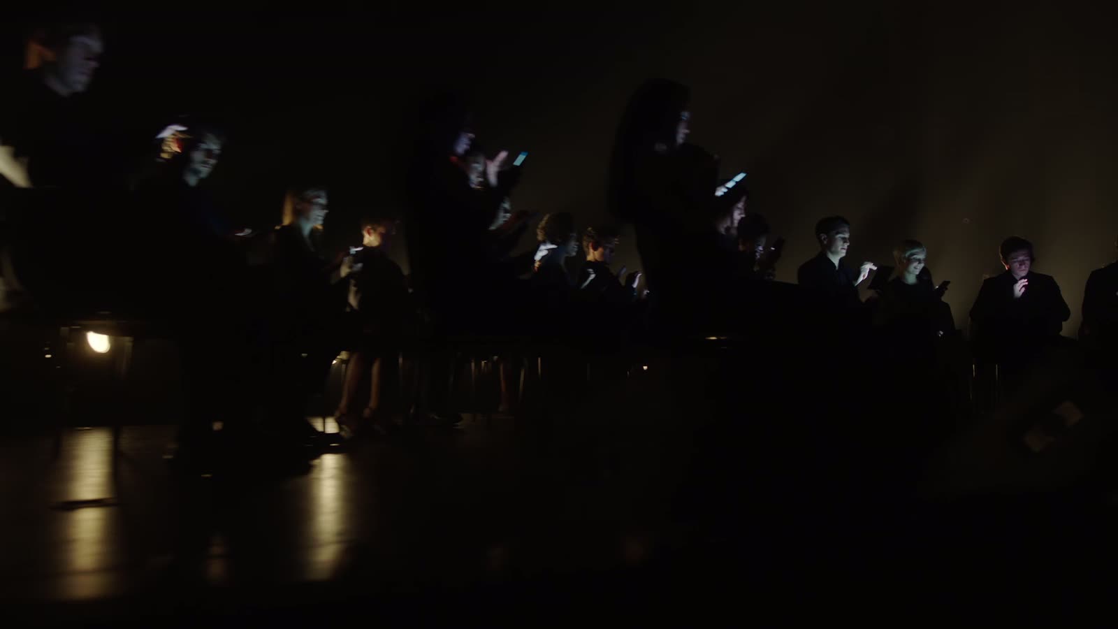 Performers holding synchronized phones during the Yahoo Mobile Symphony production
